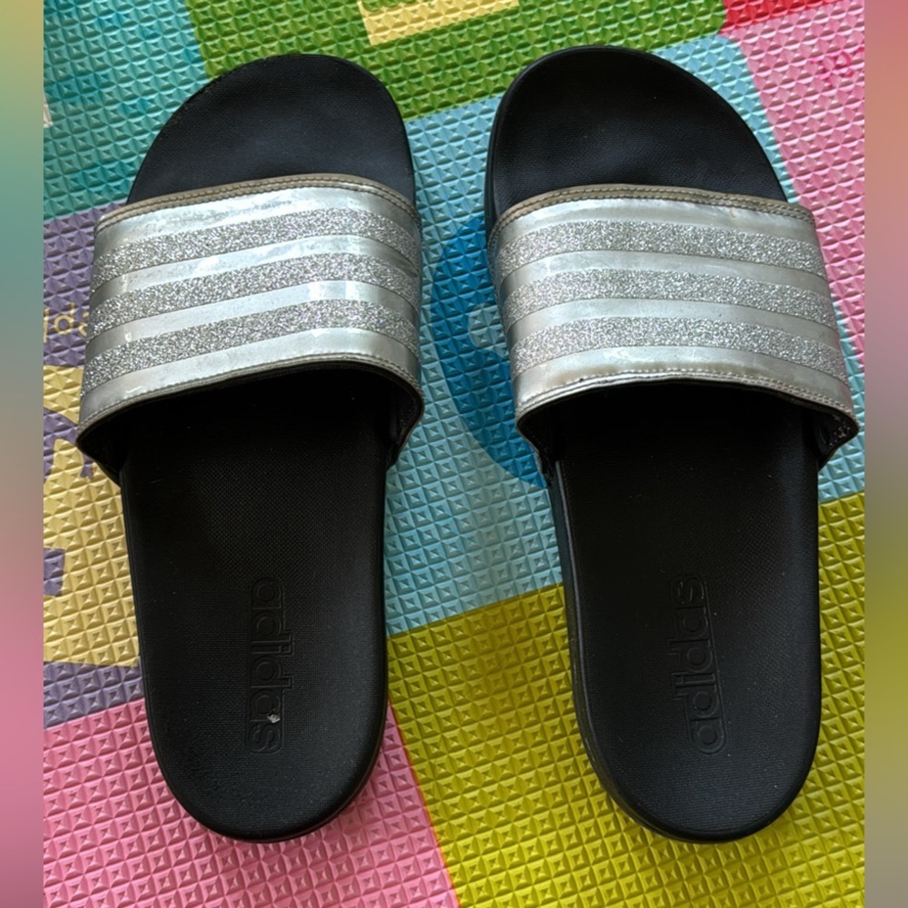 Silver and black adidas slides